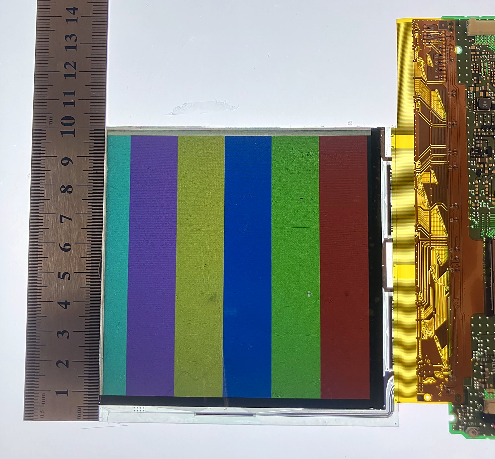 Resized LCD panel under test — color-bar pattern with dimensional measurement and driver board